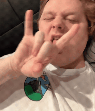 A Man Wearing A White Shirt With A Picture Of A Mountain On It Is Making A Funny Face GIF