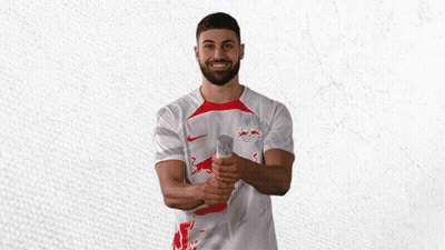 A Man Wearing A White Shirt With A Red Bull Logo On It GIF
