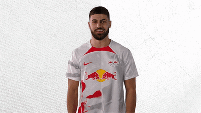 A Man Wearing A White Shirt With A Red Bull On The Front GIF