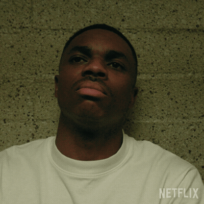 A Man Wearing A White Shirt With Netflix Written On The Sleeve GIF