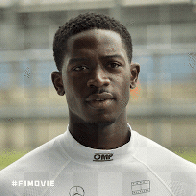 A Man Wearing A White Shirt With Omp On The Collar GIF