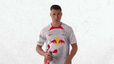 A Man Wearing A White Shirt With Red Bulls On The Front GIF