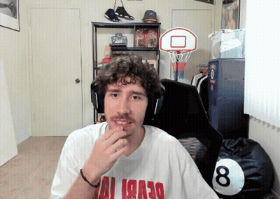 A Man Wearing A White Shirt With Red Letters That Says ' Miami ' On It GIF