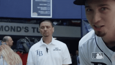 A Man Wearing A White Shirt With The Letters Fb On The Front GIF
