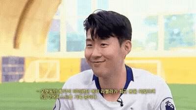 A Man Wearing A White Shirt With The Number 20 On It Smiles GIF