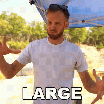 A Man Wearing A White Shirt With The Word Large On The Front GIF