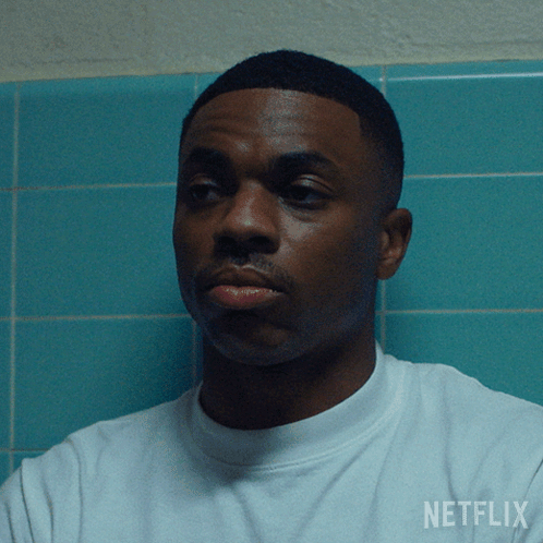 A Man Wearing A White Shirt With The Word Netflix On The Back GIF