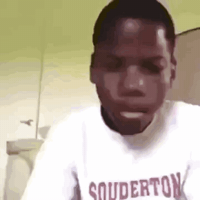 A Man Wearing A White Shirt With The Word Souderton On It . GIF