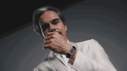 A Man Wearing A White Suit And A Black Watch GIF