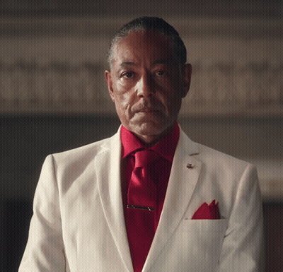 A Man Wearing A White Suit And Red Tie GIF