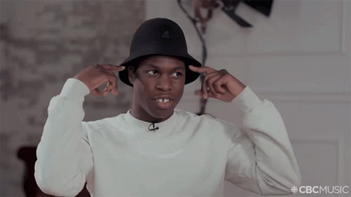 A Man Wearing A White Sweater And A Black Hat With The Hashtag Cbcmusic On The Bottom GIF