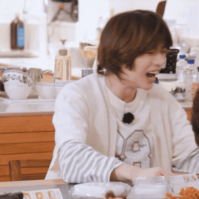 A Man Wearing A White Sweater With The Number 8 On It GIF