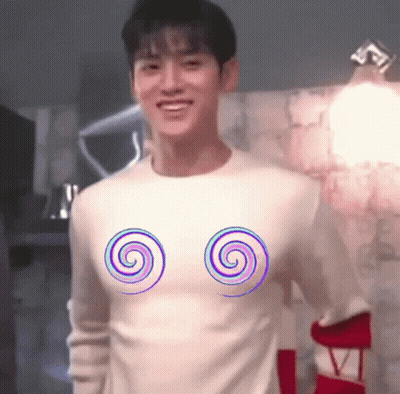 A Man Wearing A White Sweater With Two Spirals On It . GIF