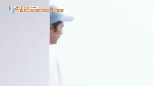 A Man Wearing A White Sweatshirt And A Blue Hat Is Smiling And Holding His Hands To His Chest . GIF