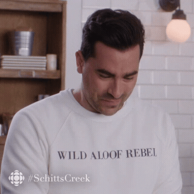 A Man Wearing A White Sweatshirt That Says Wild Aloof Rebel GIF