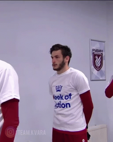 A Man Wearing A White T-Shirt That Says ' Caffe Week Of Action ' GIF