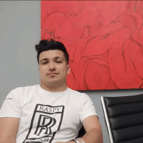 A Man Wearing A White T-Shirt That Says Raspy On It GIF