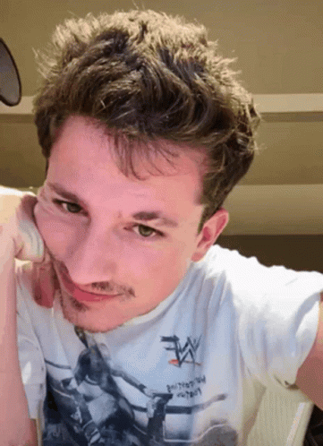 A Man Wearing A White T-Shirt That Says Wrestling On It GIF