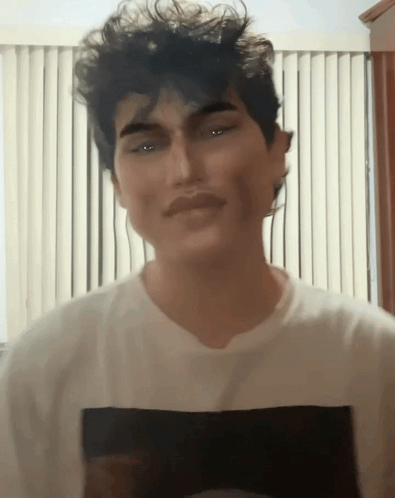 A Man Wearing A White T-Shirt With A Black Square On The Front GIF