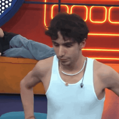 A Man Wearing A White Tank Top And Pearl Necklace GIF