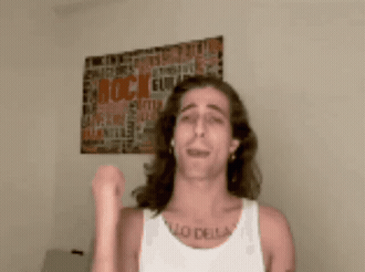 A Man Wearing A White Tank Top Has A Tattoo On His Chest That Says " Lo Della " GIF