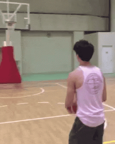 A Man Wearing A White Tank Top With A Basketball Logo On The Back Is Playing Basketball GIF