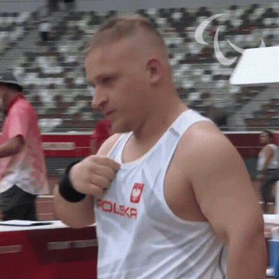A Man Wearing A White Tank Top With Polska On It GIF