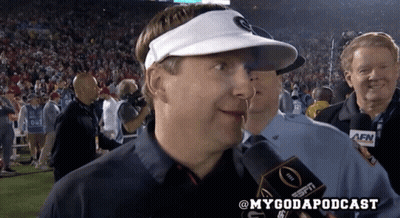 A Man Wearing A White Visor Is Talking Into A Espn Radio Microphone GIF