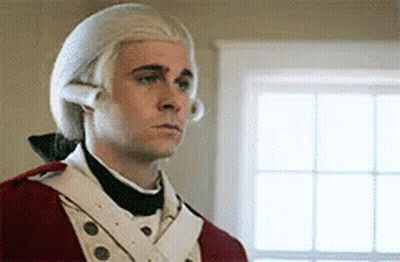 A Man Wearing A Wig And A Red Uniform Is Standing In Front Of A Window . GIF