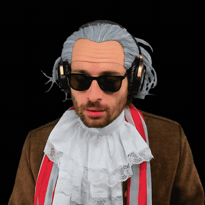 A Man Wearing A Wig And Headphones Has A White Lace Collar GIF
