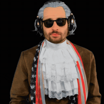 A Man Wearing A Wig And Sunglasses Has A Scarf Around His Neck GIF