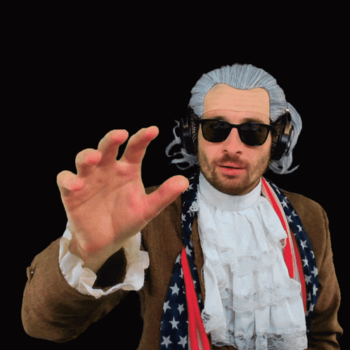 A Man Wearing A Wig And Sunglasses Has His Hand Out GIF