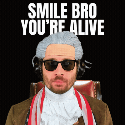 A Man Wearing A Wig And Sunglasses Has The Words Smile Bro You 'Re Alive Above Him GIF