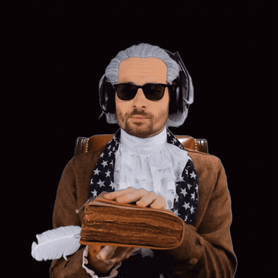 A Man Wearing A Wig And Sunglasses Is Holding A Book And A Feather GIF