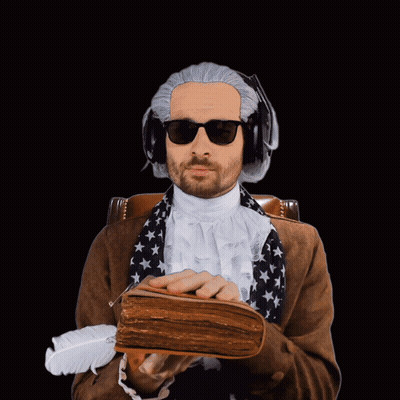 A Man Wearing A Wig And Sunglasses Is Holding A Book And A Feather GIF