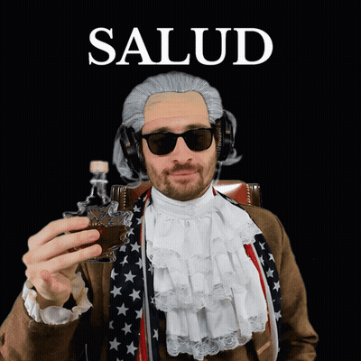 A Man Wearing A Wig And Sunglasses Is Holding A Shot Glass And The Word Salud Is Above Him GIF