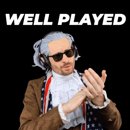 A Man Wearing A Wig And Sunglasses Is Standing In Front Of A Sign That Says Well Played GIF