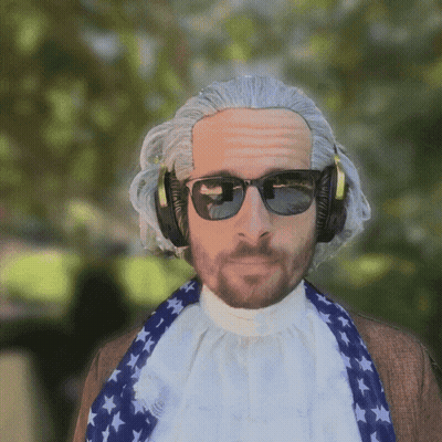 A Man Wearing A Wig And Sunglasses Is Wearing Headphones And A Scarf GIF