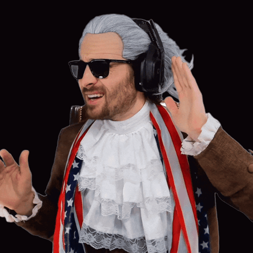 A Man Wearing A Wig And Sunglasses Is Wearing Headphones And An American Flag GIF