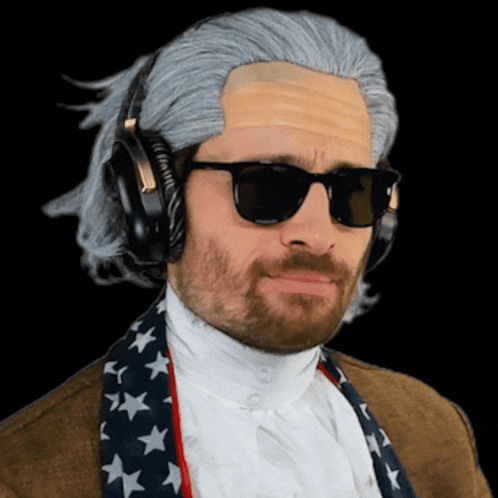 A Man Wearing A Wig And Sunglasses Is Wearing Headphones And An American Flag Scarf GIF
