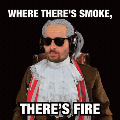 A Man Wearing A Wig And Sunglasses Says Where There 'S Smoke , There 'S Fire GIF