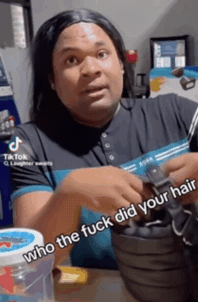 a man wearing a wig is holding a black purse and says who the fuck did your hair .