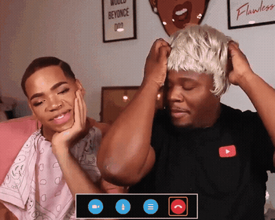 A Man Wearing A Wig Talks To Another Man GIF