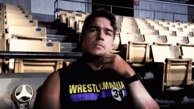 A Man Wearing A Wrestlemania 34 Tank Top GIF