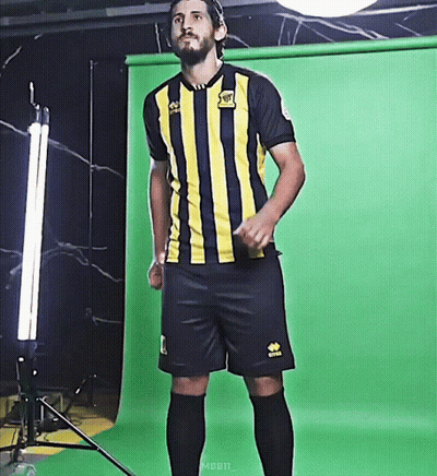 A Man Wearing A Yellow And Black Striped Jersey With The Word Rabbit On The Front GIF