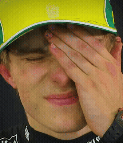 A Man Wearing A Yellow And Green Hat Covering His Face GIF