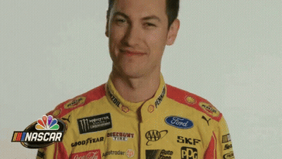 A Man Wearing A Yellow And Red Racing Suit With Nascar Written On The Bottom GIF