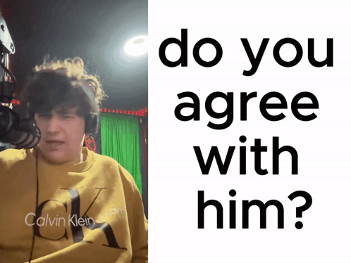A Man Wearing A Yellow Calvin Klein Sweatshirt Is Next To A Sign That Says Do You Agree With Him? GIF