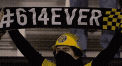 A Man Wearing A Yellow Hard Hat Holds Up A Scarf That Says # 614Ever GIF