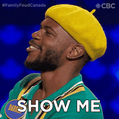 A Man Wearing A Yellow Hat And A Green Shirt Says Show Me GIF